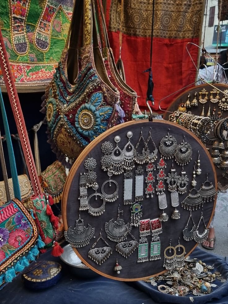 Traditional oxidized silver earrings and handmade embroidered Rajasthani bags in Udaipur local market